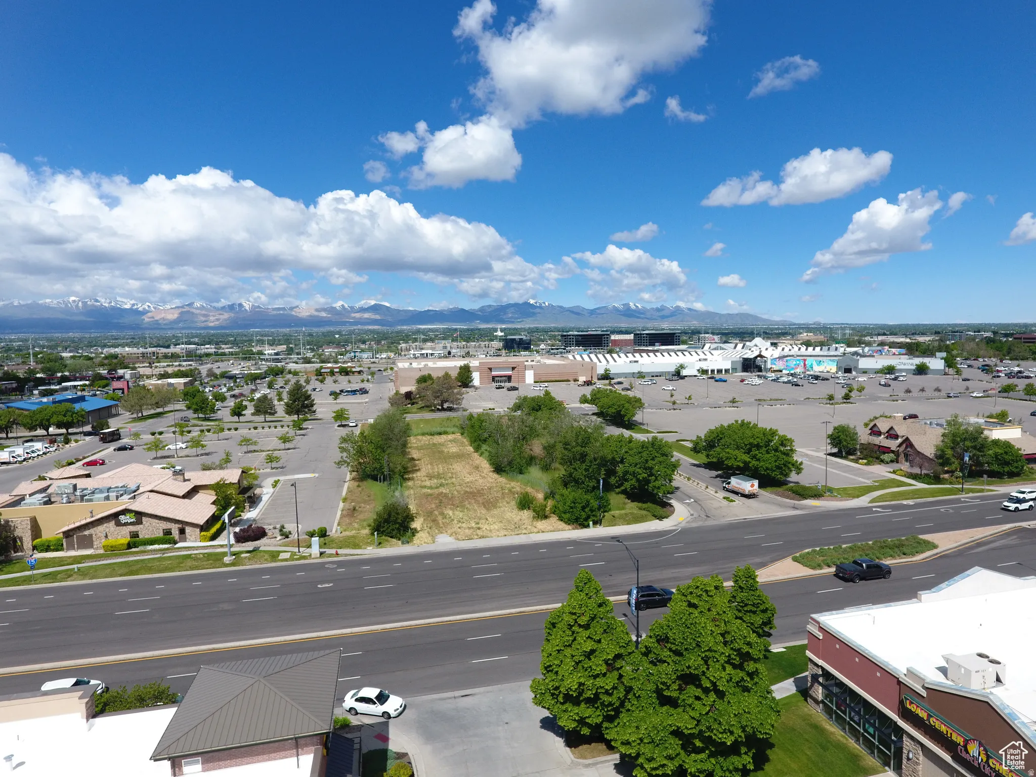 Expansive commercial lot with direct street frontage, featuring a clear, level buildable area, surrounded by established retail developments, and offering prominent visibility