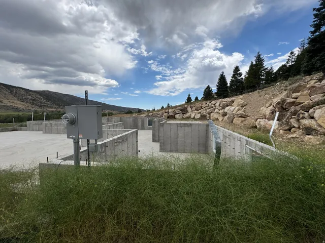 Concrete foundation with perimeter walls and a utility meter box