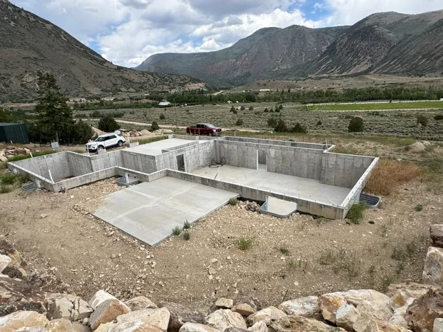 New construction foundation featuring concrete walls and integrated concrete patio