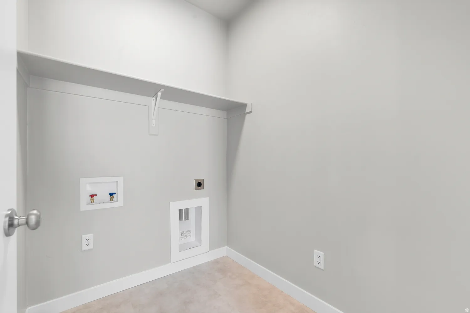 Utility room featuring neutral wall color, overhead shelving, and carpet flooring