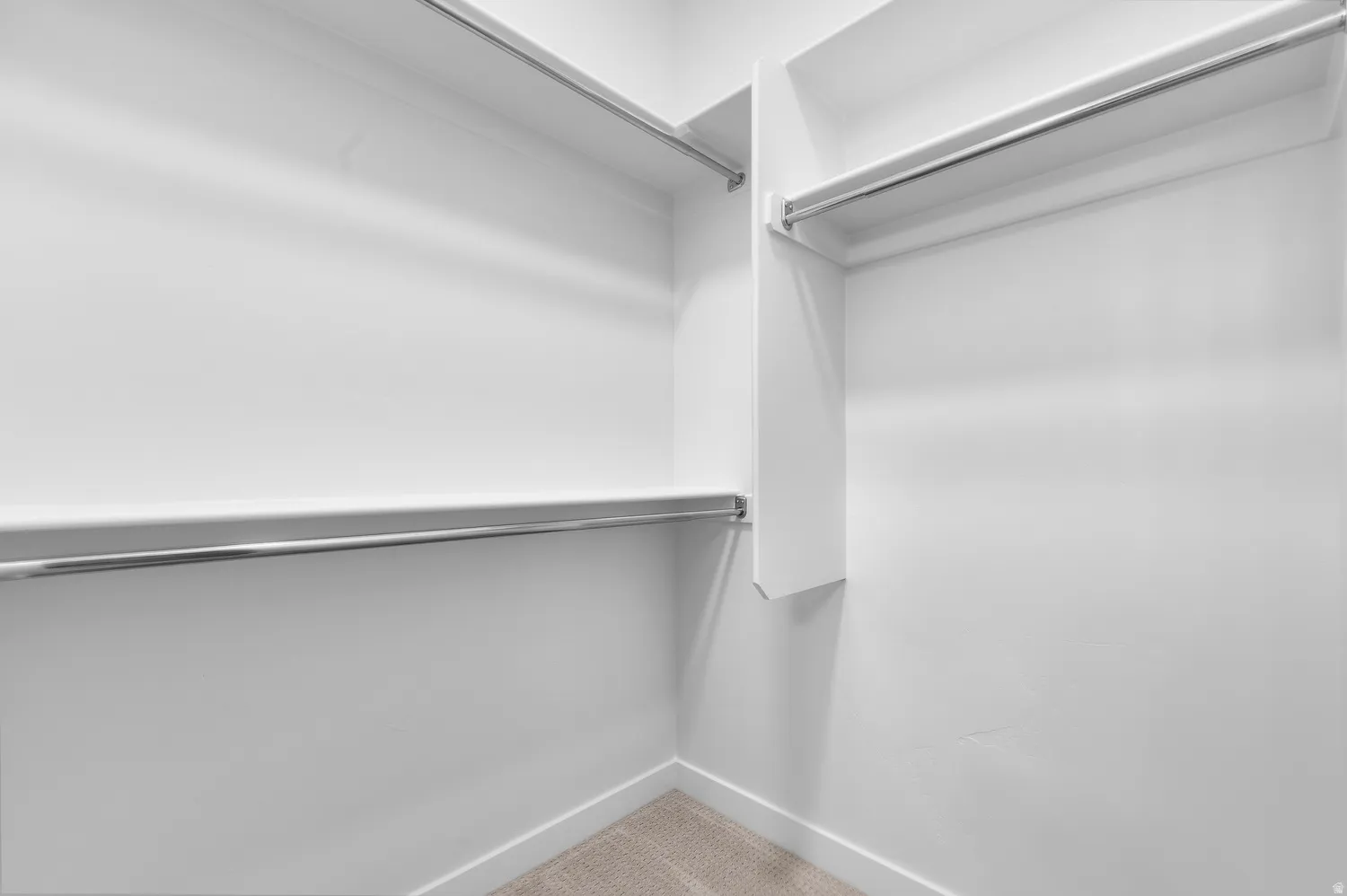 Built-in shelving with multiple chrome hanging rods
