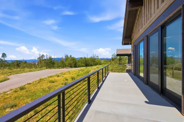Expansive concrete patio with metal horizontal railing