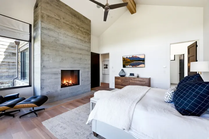 Vaulted ceiling featuring a natural wood beam and ceiling fan