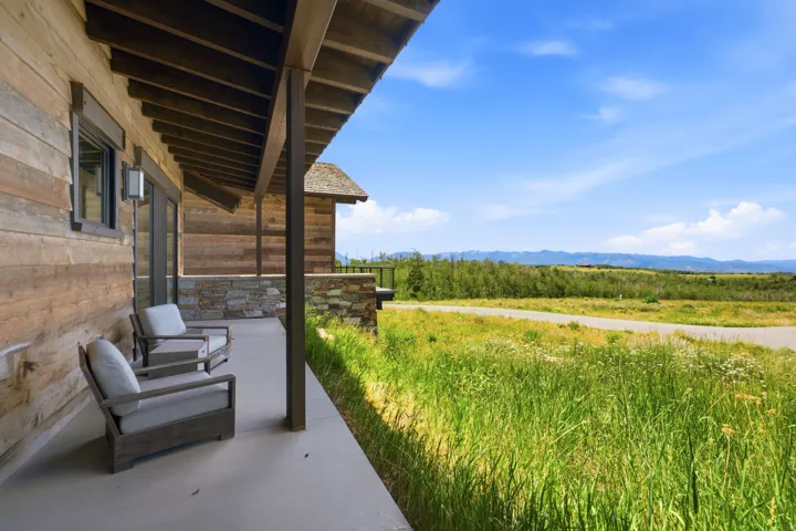 Covered outdoor patio featuring a concrete surface and natural wood-planked ceiling