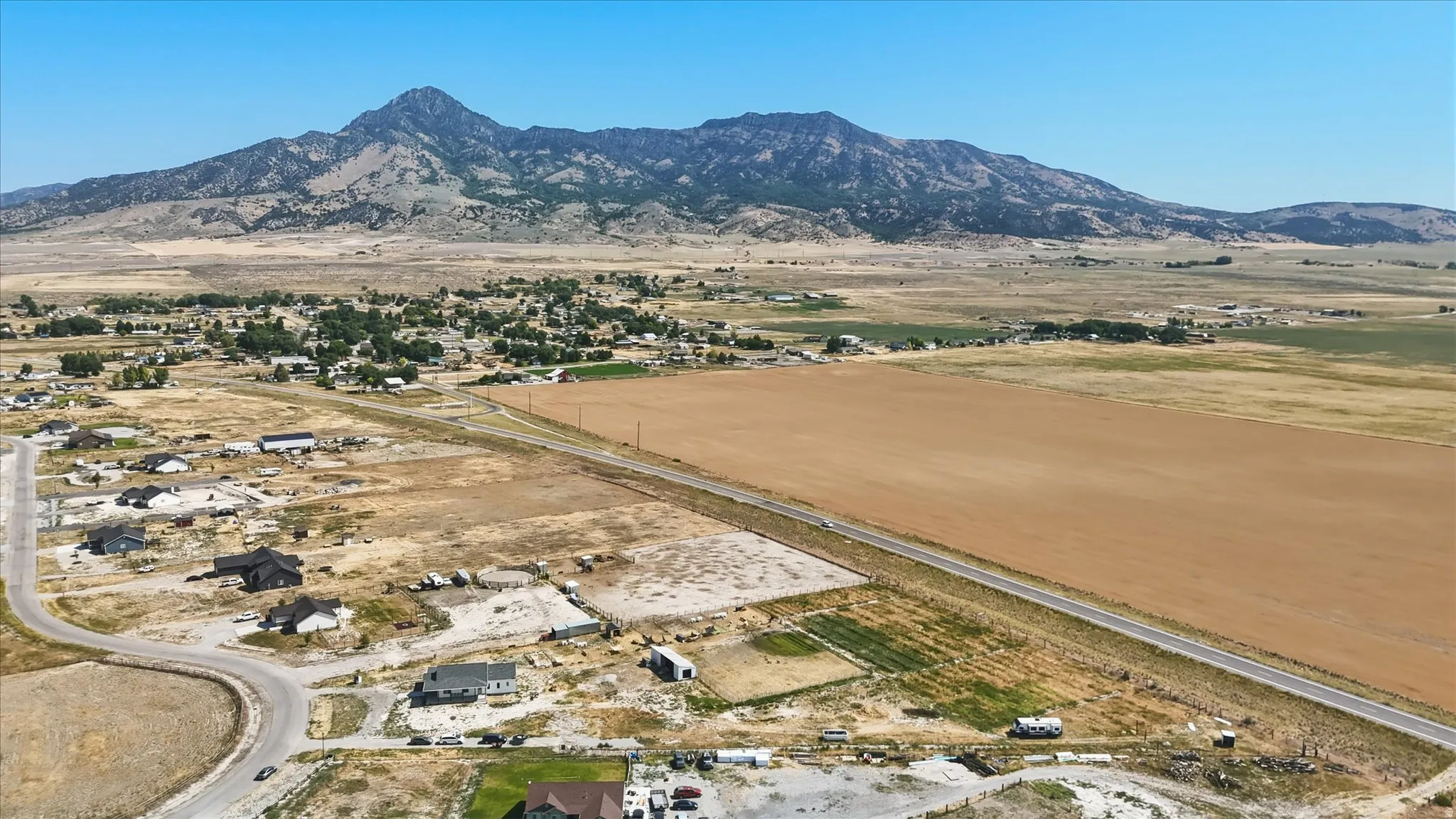 Expansive rural landscape with a prominent mountain range backdrop