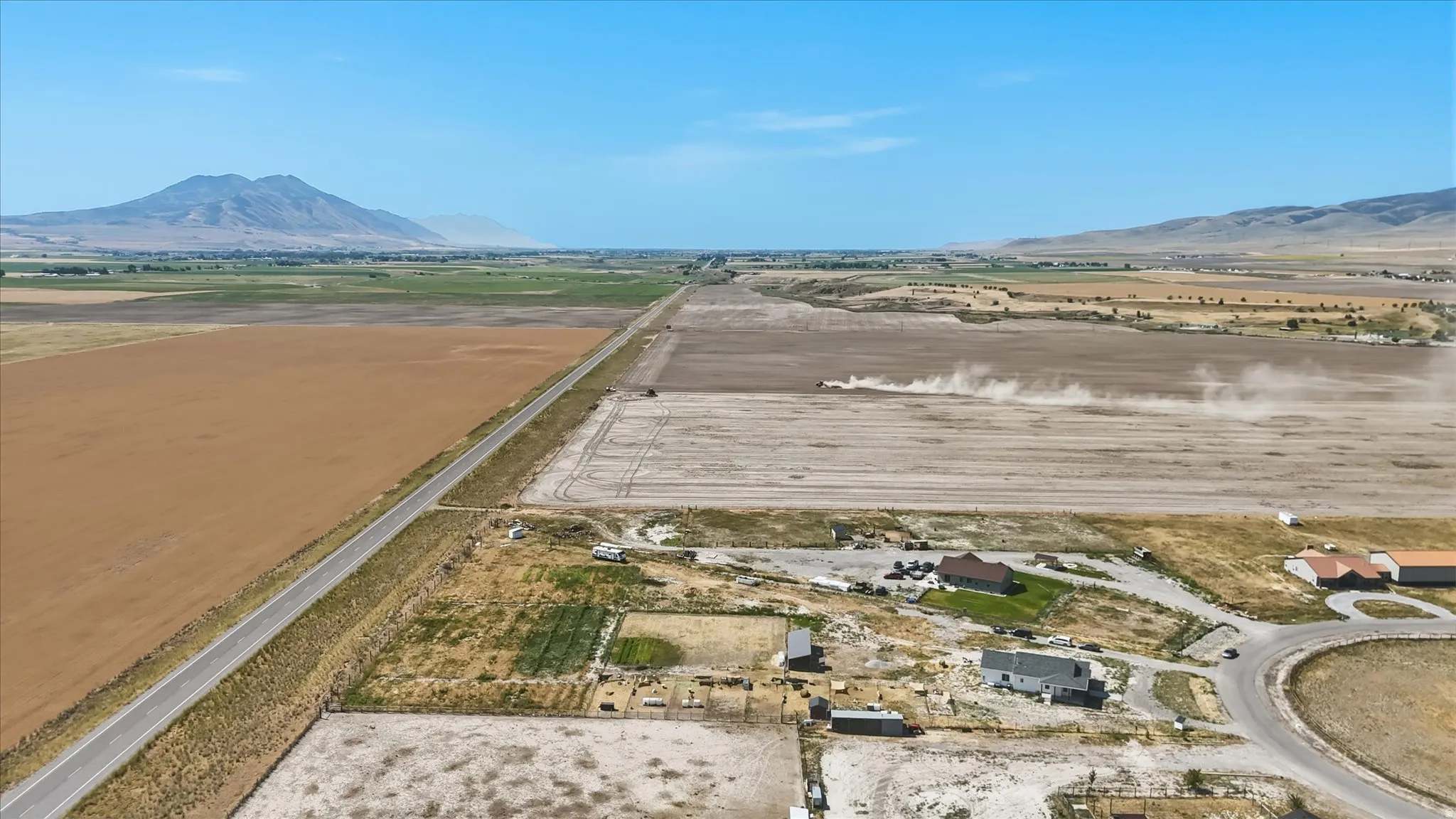 Expansive land parcels with clear skies and distant mountain ranges