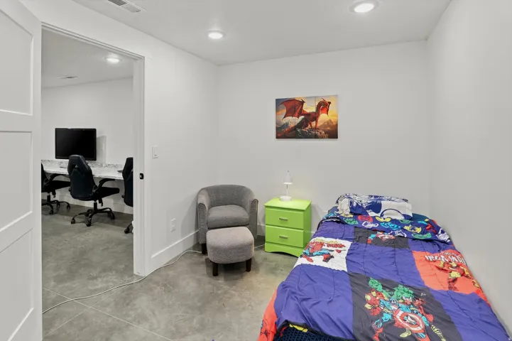 Bright room featuring recessed lighting, a wide doorway, and concrete flooring