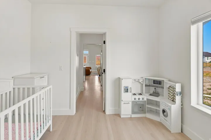 Bright room with light wood-finish flooring and white walls