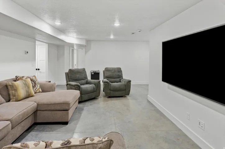 Spacious open area featuring concrete flooring and recessed ceiling lights
