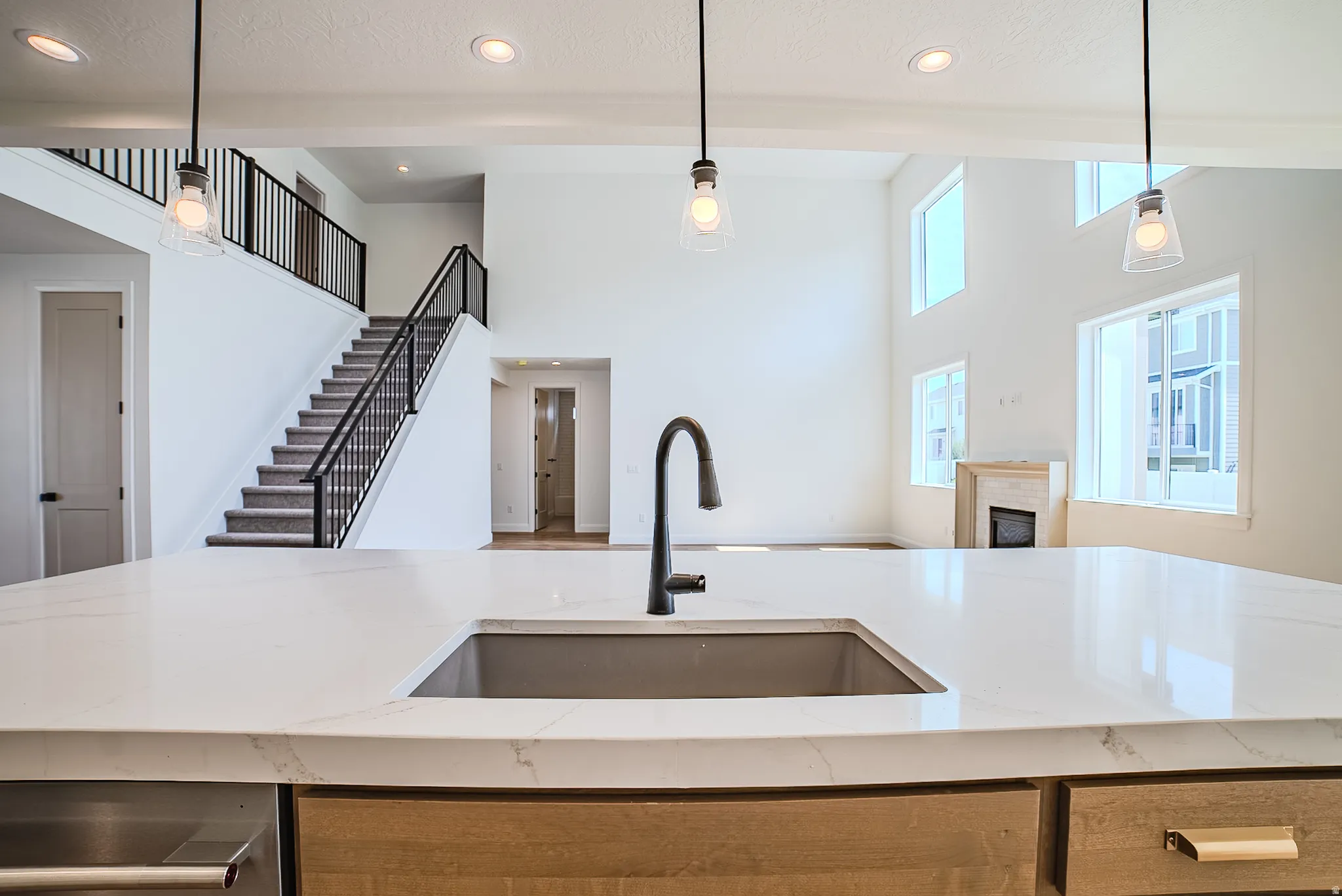 Kitchen island featuring a single-basin sink with a matte black gooseneck faucet