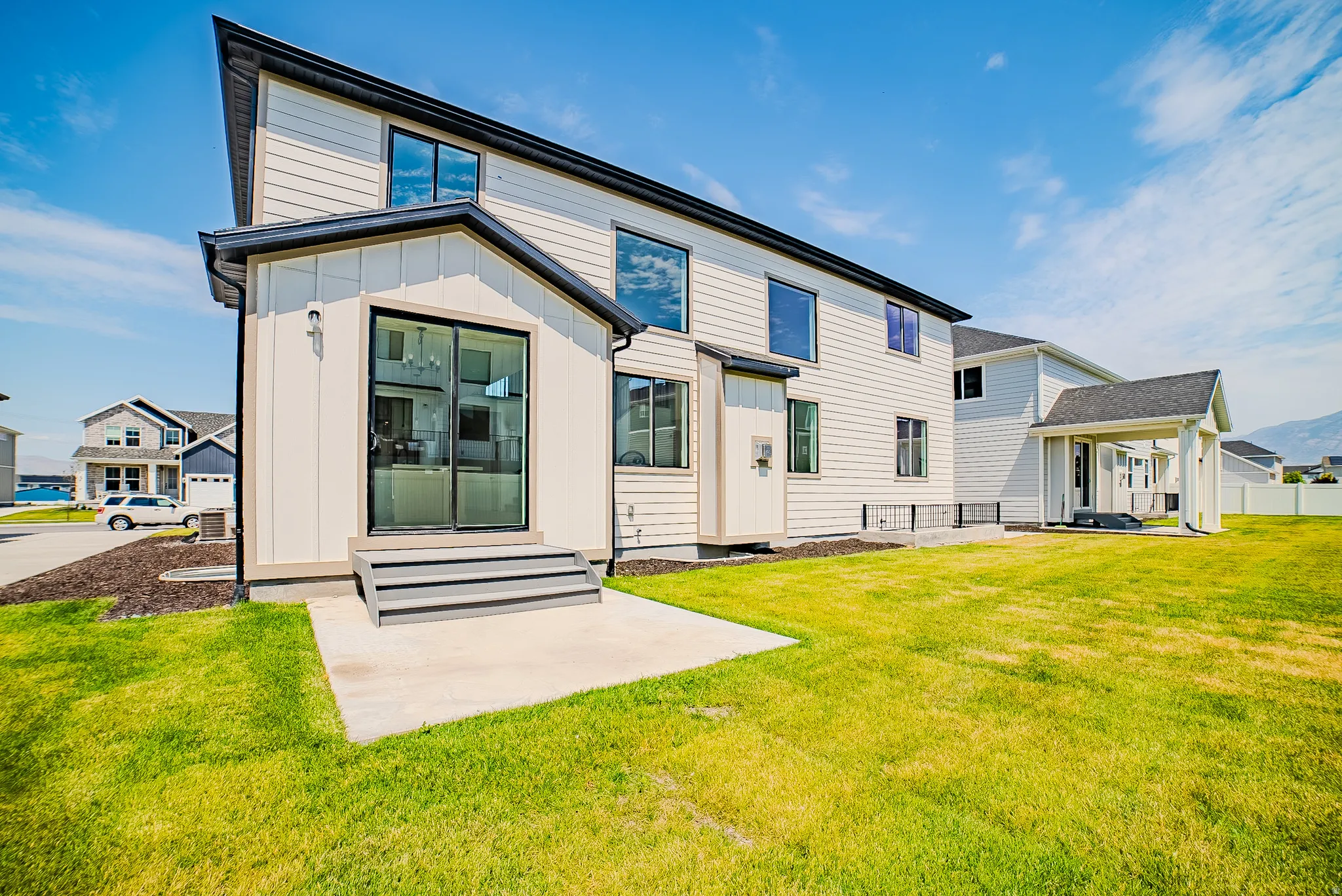 Exterior featuring light-colored horizontal siding and vertical board and batten accents