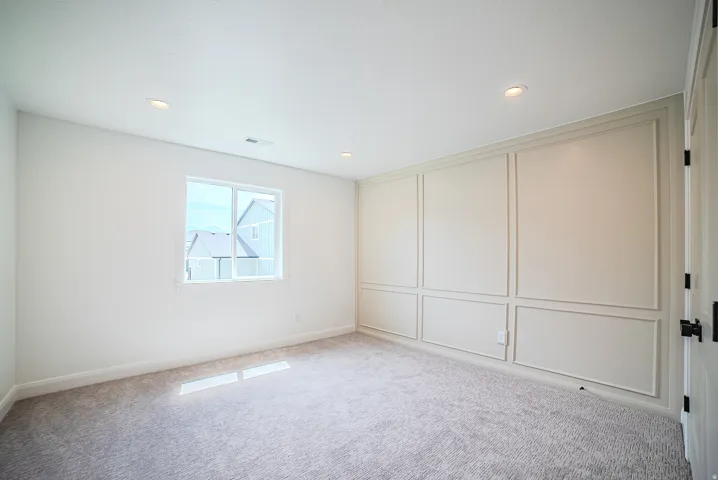 Room with recessed lighting, a single window, and plush carpet flooring