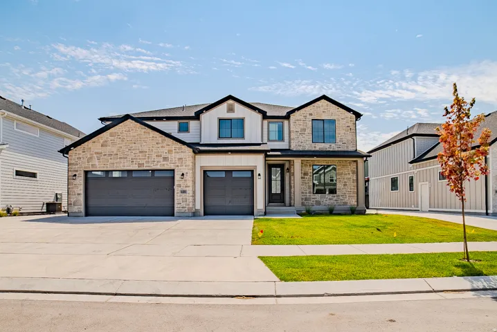 Contemporary stone and siding exterior with dark trim accents