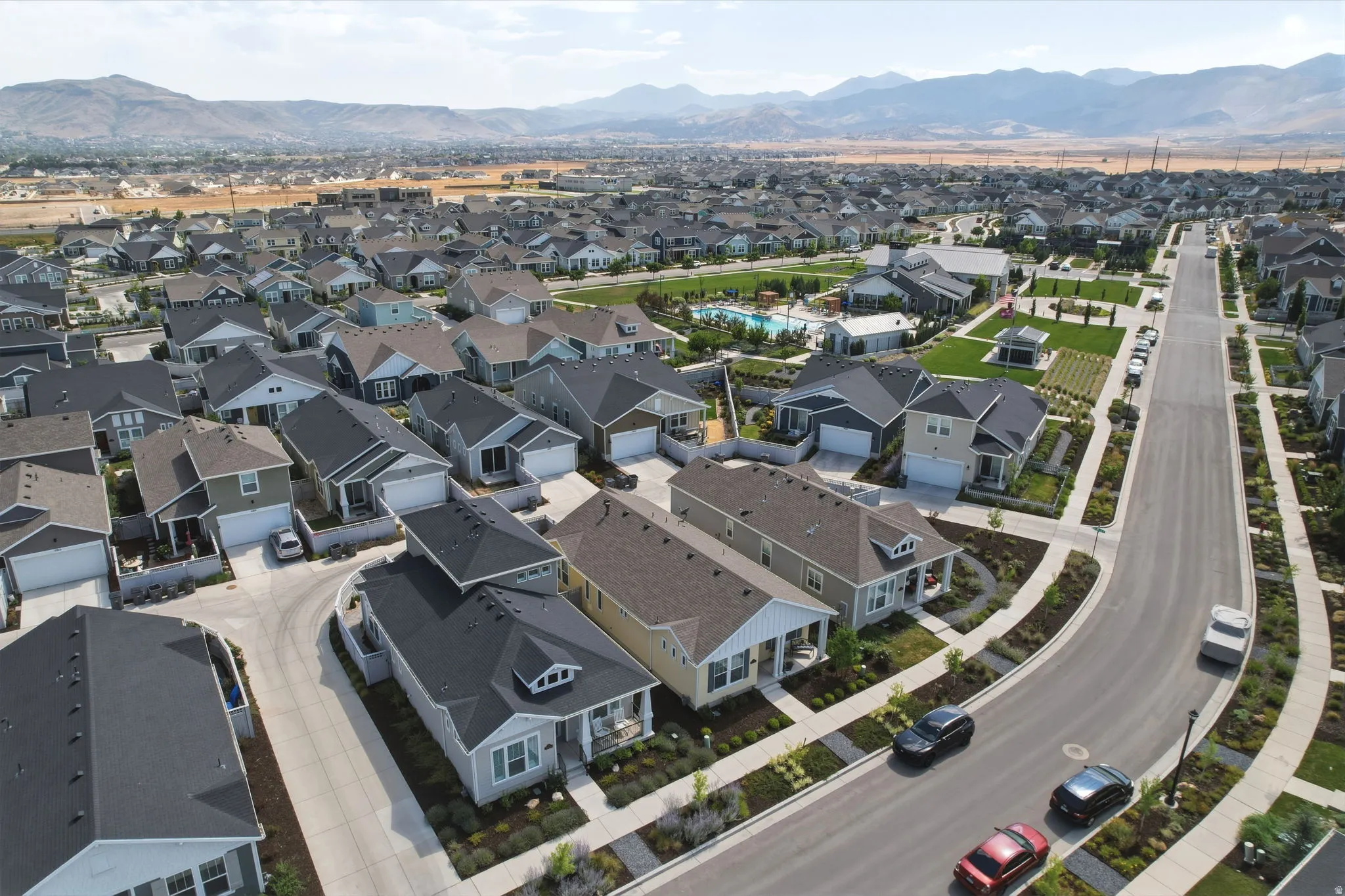 Residential neighborhood featuring varied single-family homes, wide paved streets, and landscaped sidewalks