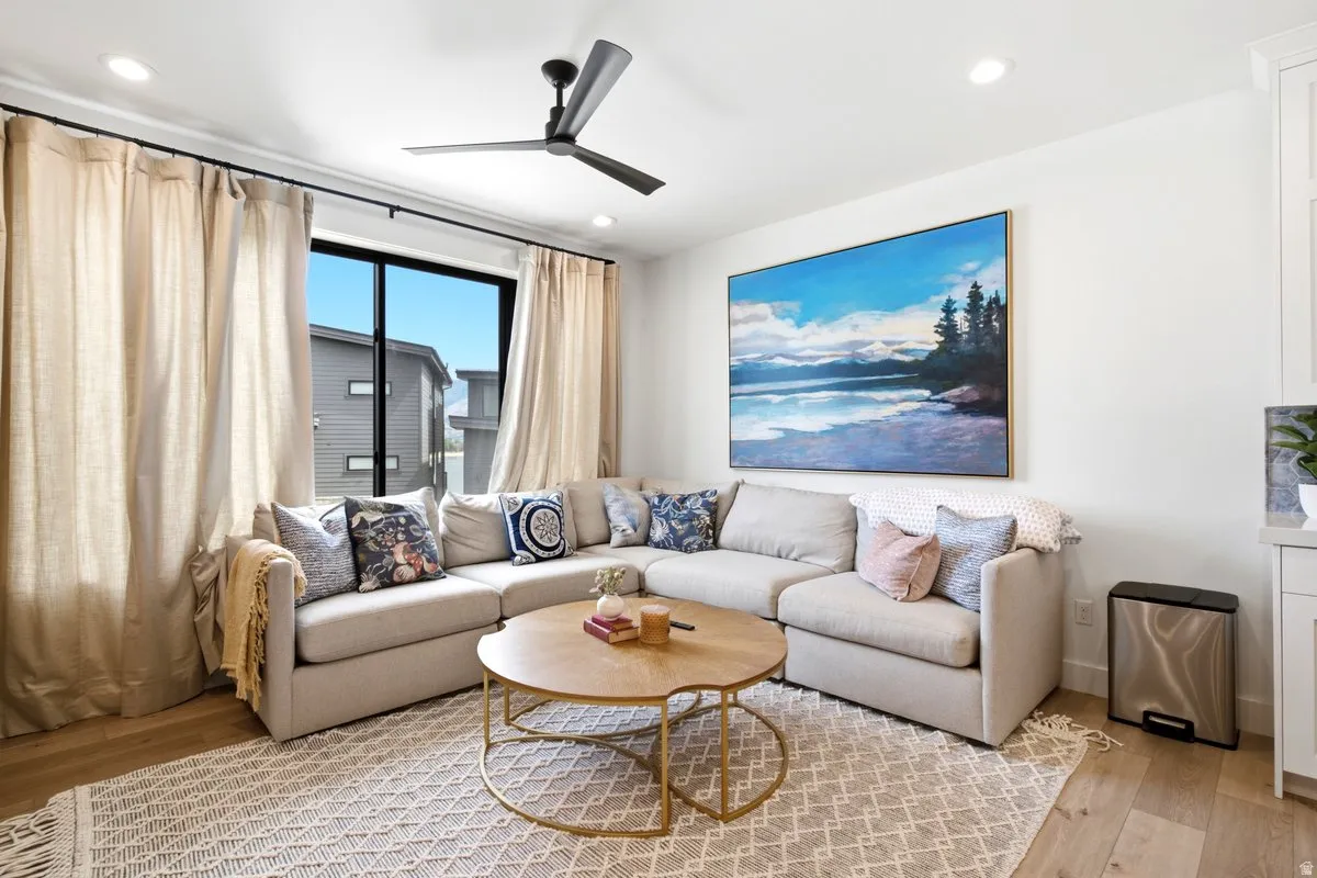 Light wood-finish flooring complements the neutral color palette of this living space