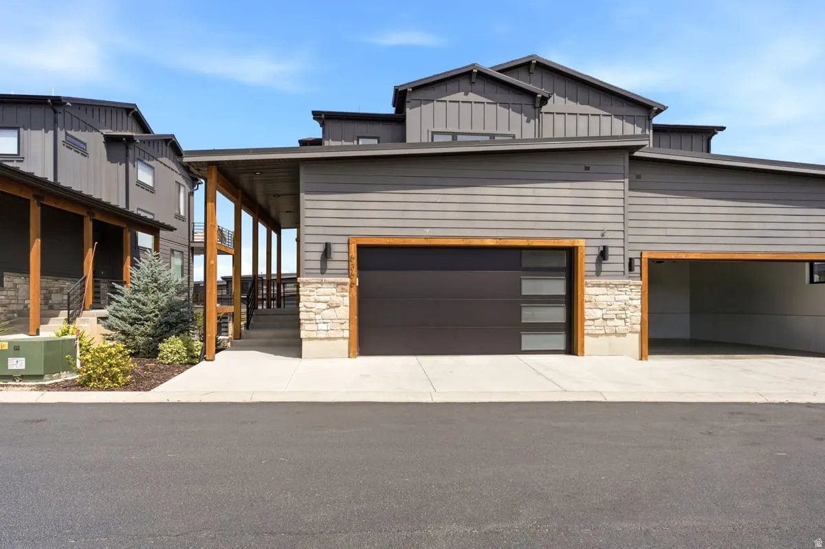 Modern exterior architecture featuring a dark gray horizontal siding and board and batten accents