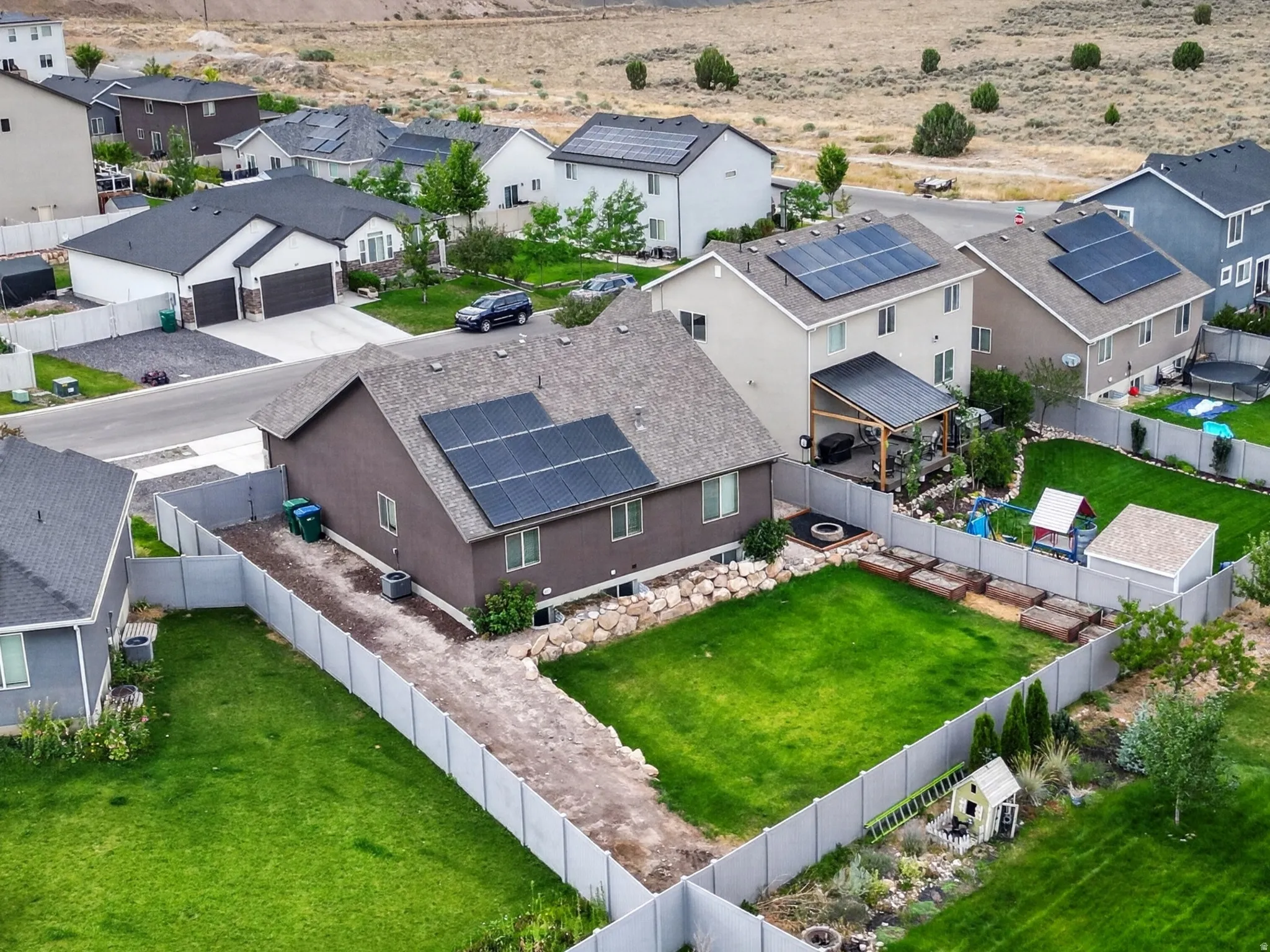 Residential neighborhood featuring a mix of single-family homes, several with solar panel installations