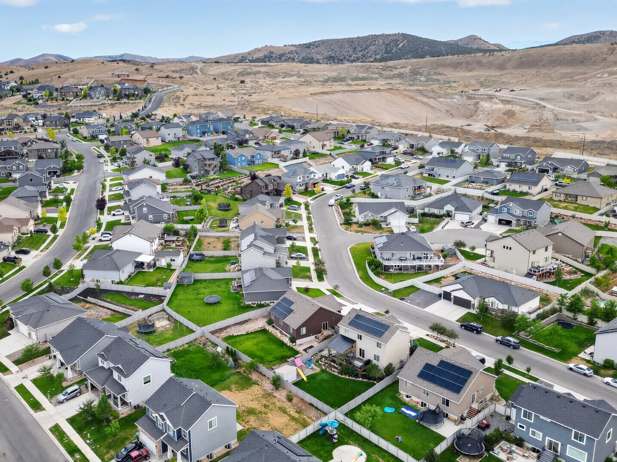 Expansive residential development featuring numerous single-family homes with pitched roofs and varied exterior finishes
