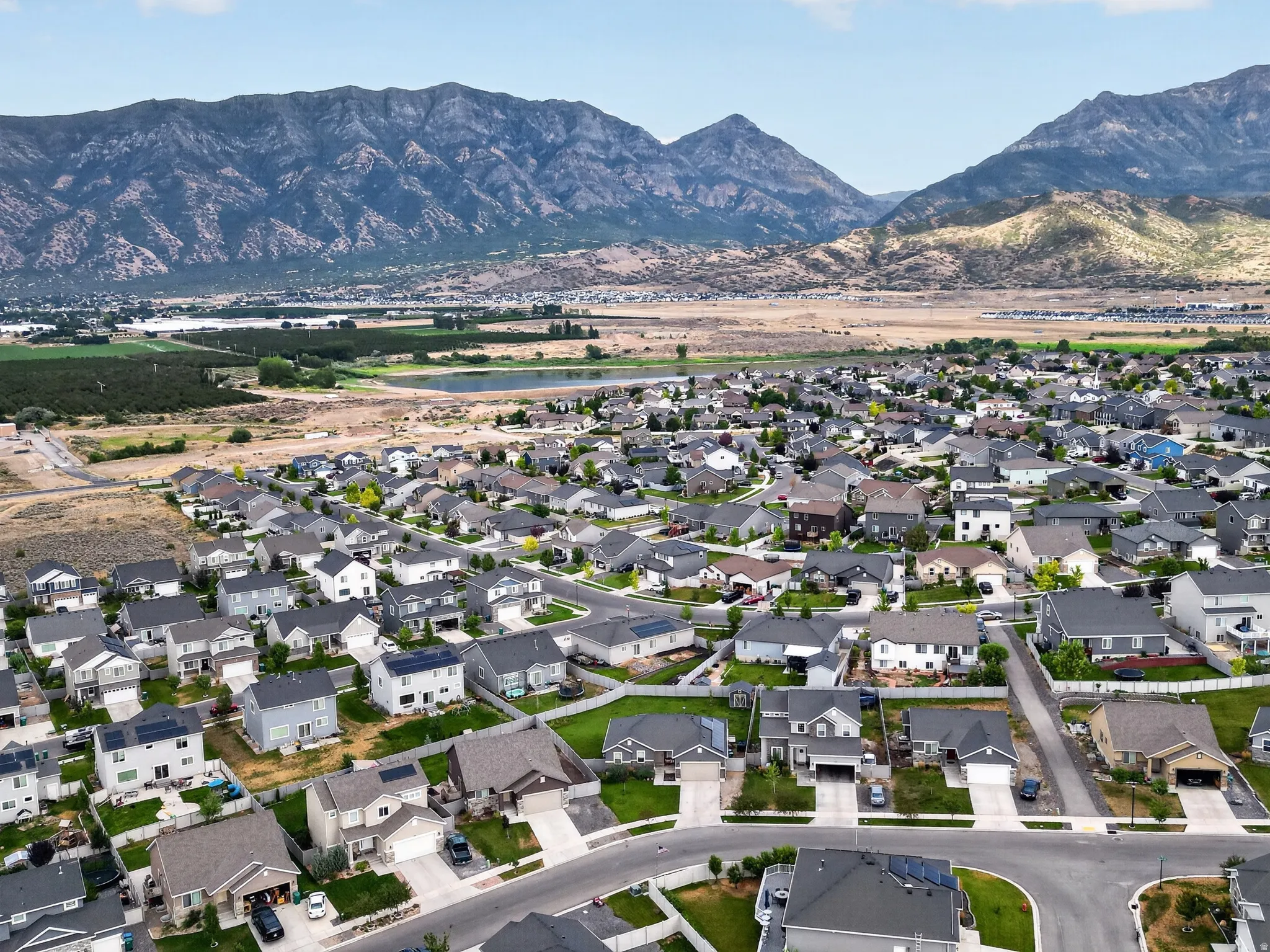 Expansive community showcasing a variety of single-family homes with mountain backdrops