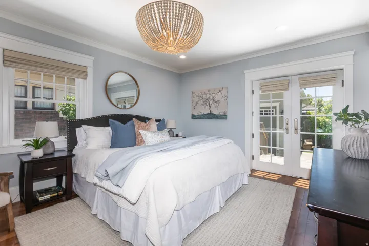 Bedroom featuring a decorative chandelier and light blue walls