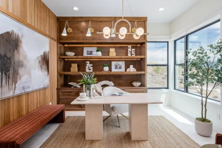 Integrated wood-paneled wall with built-in shelving, featuring recessed lighting and sconces