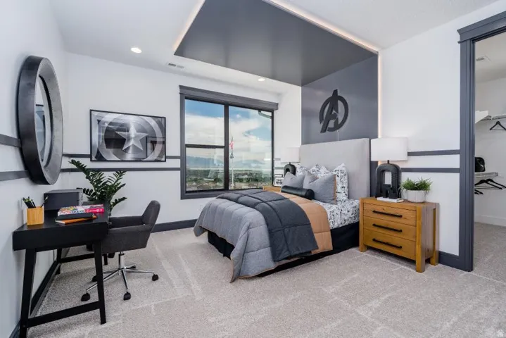 Modern bedroom suite featuring a tray ceiling with integrated recessed lighting, floor-to-ceiling windows with panoramic landscape vistas, gray and white two-tone wall treatment with horizontal accent stripe, wood-finish nightstand with drawer storage, an