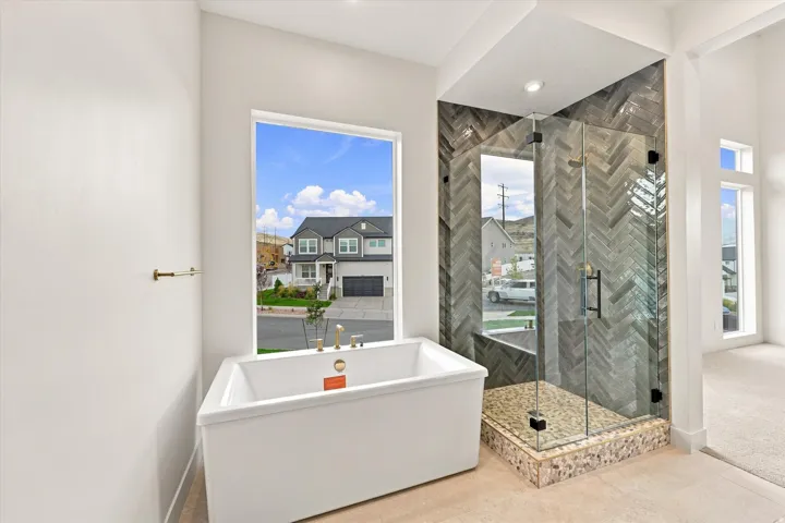 Freestanding soaking tub with gold-finish fixtures