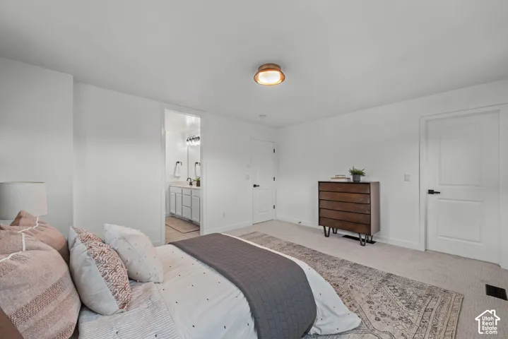 Carpeted bedroom featuring white walls and a contemporary flush-mount ceiling light