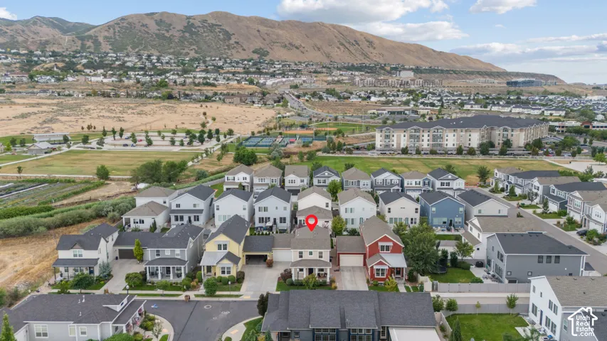 Aerial perspective showcasing a residential community with a mountainous backdrop