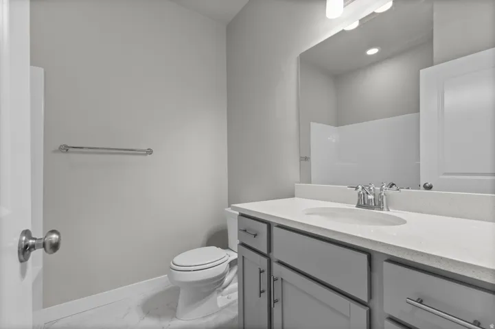Vanity with integrated sink, modern faucet, and light-toned countertop