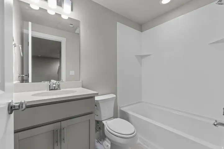 Modern vanity with an integrated sink and light-toned countertop