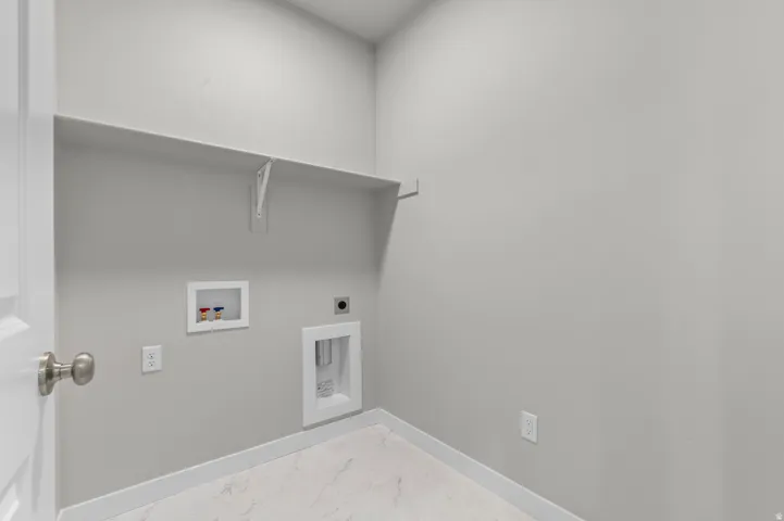 White wall shelving, neutral wall paint, and marble-look flooring