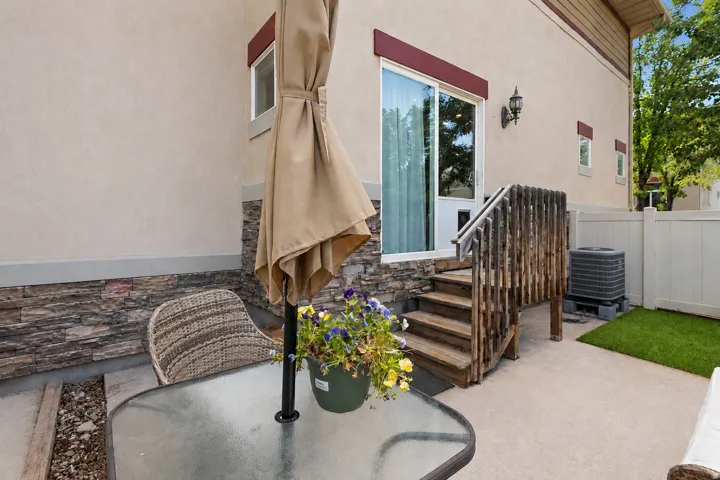 Private patio space featuring a concrete slab and artificial turf