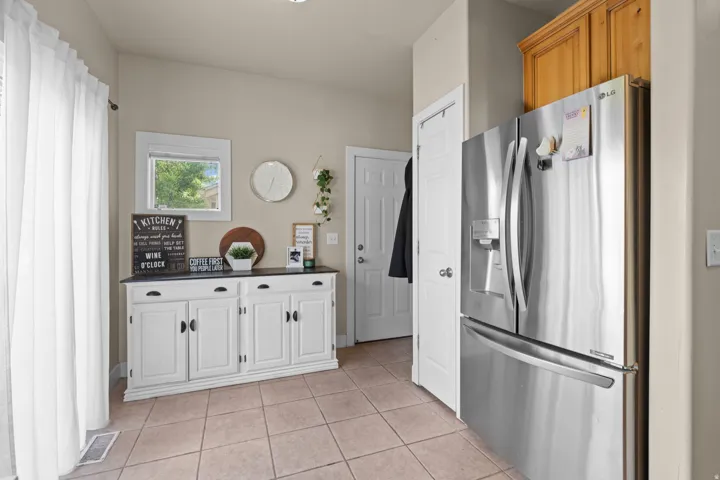 Light-toned floor tiling complements the neutral wall color