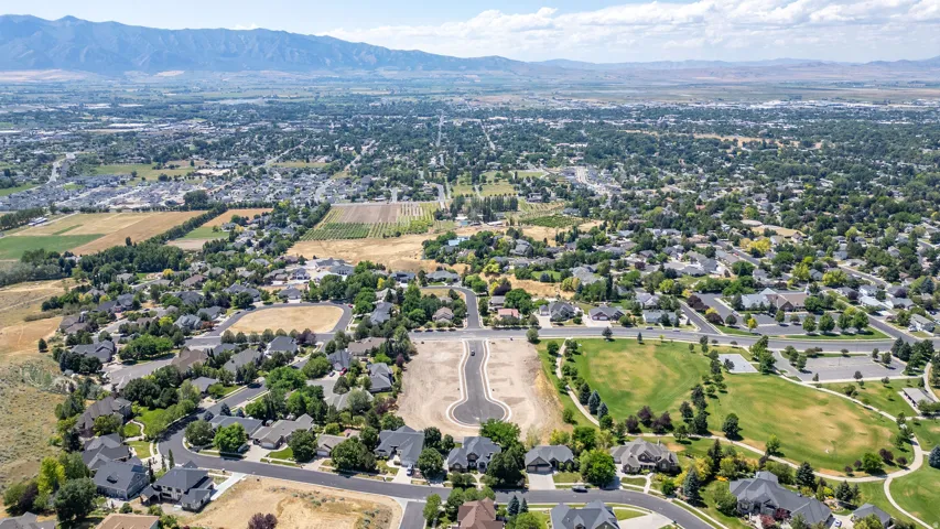 Aerial perspective showcasing a residential development with established homes and a new cul-de-sac construction site