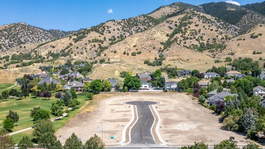 Developing cul-de-sac lot featuring new asphalt paving and concrete curbing