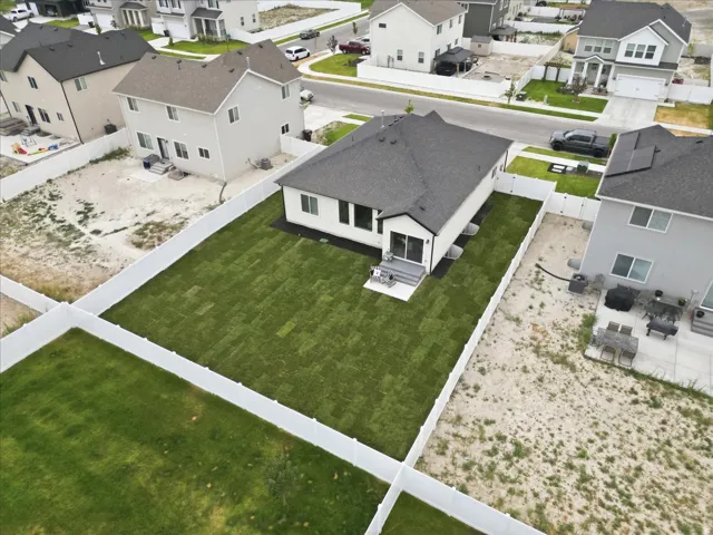 Recently installed sod lawn with a clean white privacy fence encompassing the backyard