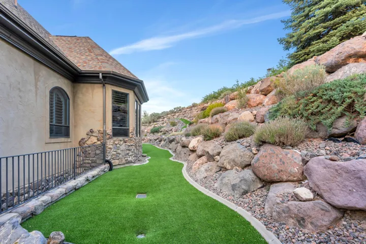 Exterior featuring stucco siding, stone accents, and a shingle roof