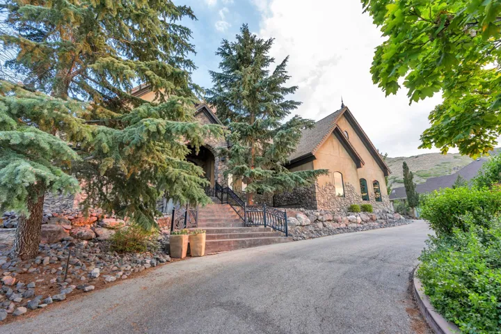 Stone and stucco exterior with multiple gables and arched entry