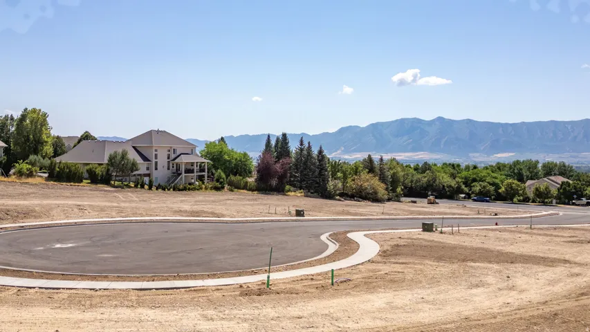 New construction land parcel featuring a paved cul-de-sac and concrete sidewalks