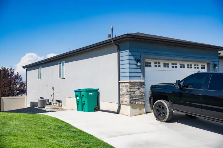 Exterior facade featuring stucco siding and blue horizontal siding accents