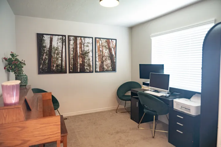 Neutral wall color with a window featuring blinds