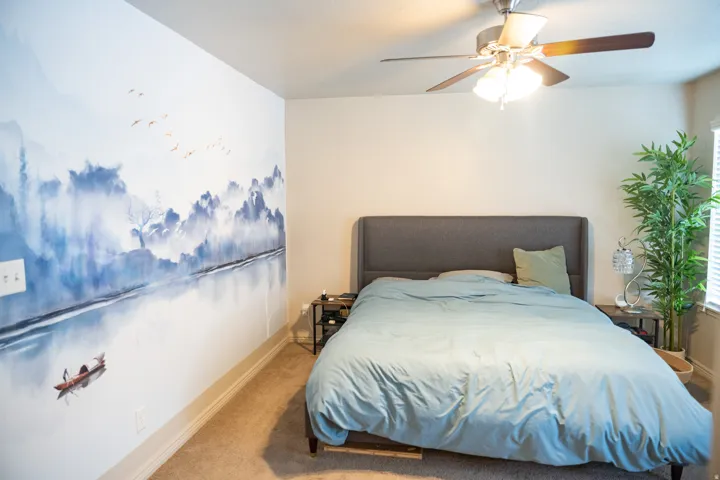 Room featuring a prominent accent wall with a detailed scenic mural