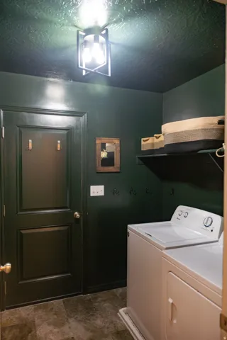 Dedicated laundry area featuring a full-size washer and dryer