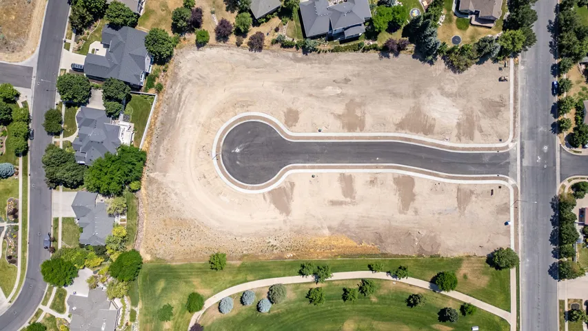Expansive undeveloped parcel featuring a cul-de-sac and paved street infrastructure