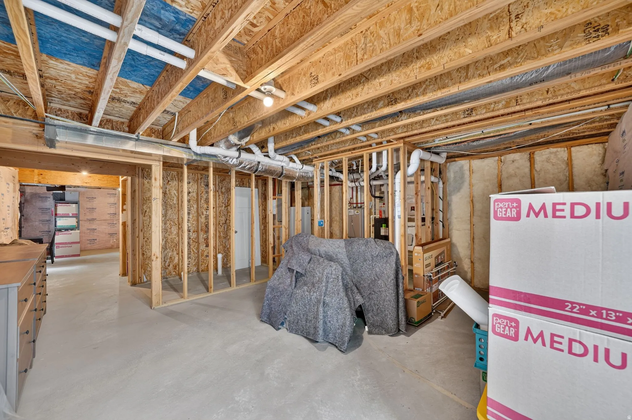 Open basement space featuring exposed wood joists and structural framing
