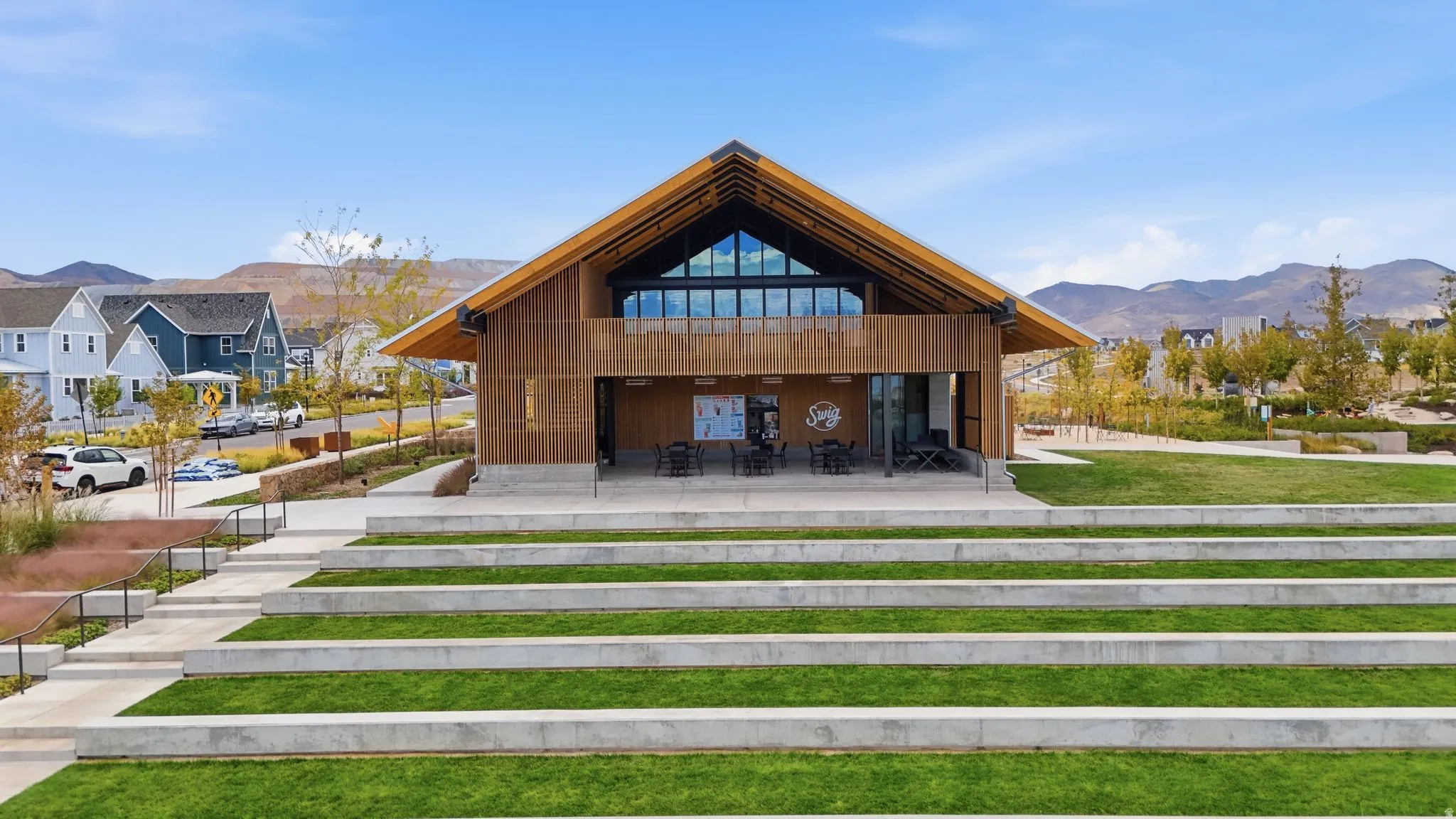 Modern community building featuring a gabled roofline and extensive glass façade