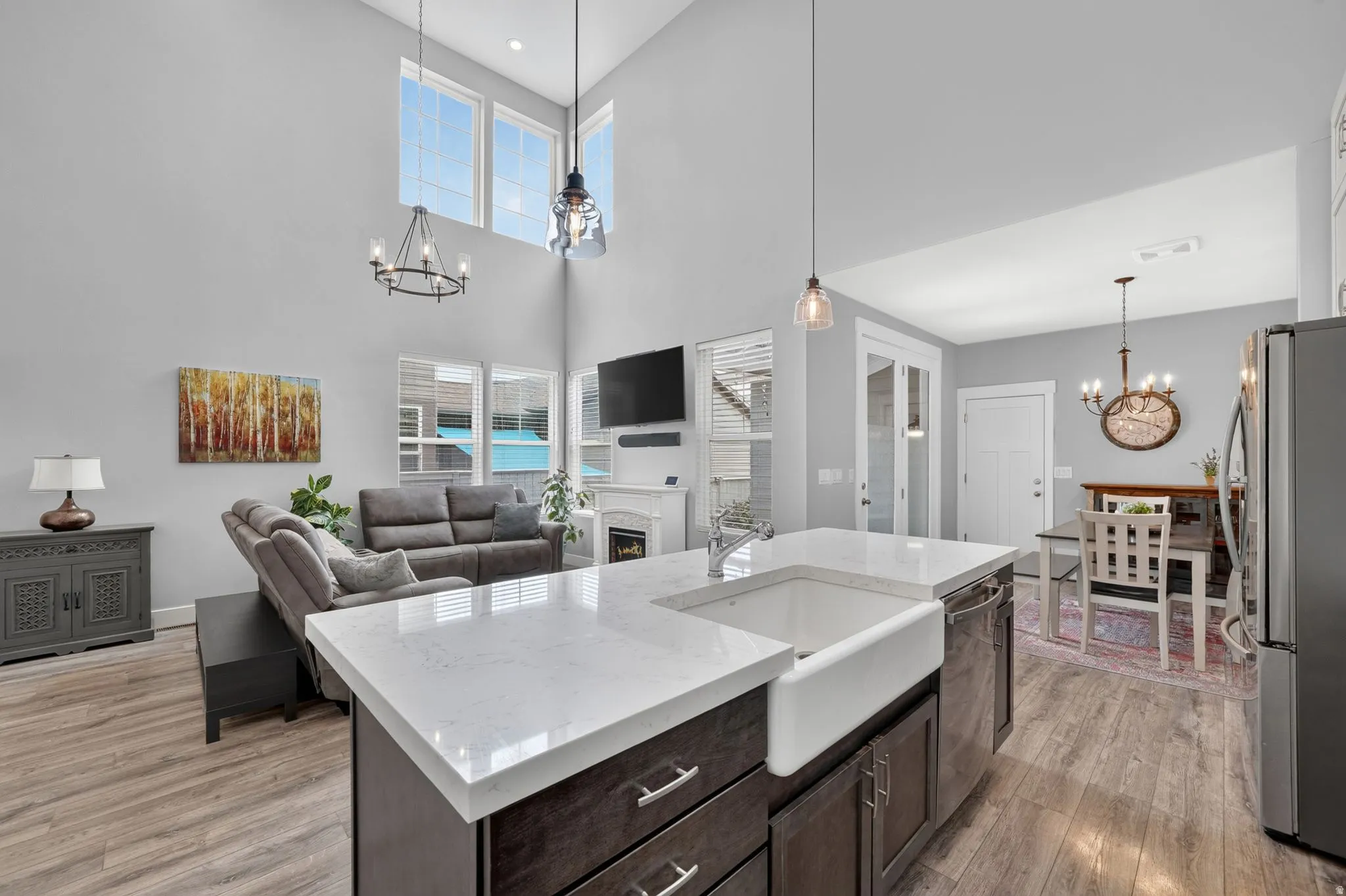 Spacious kitchen island with a white farmhouse sink and light-toned countertops