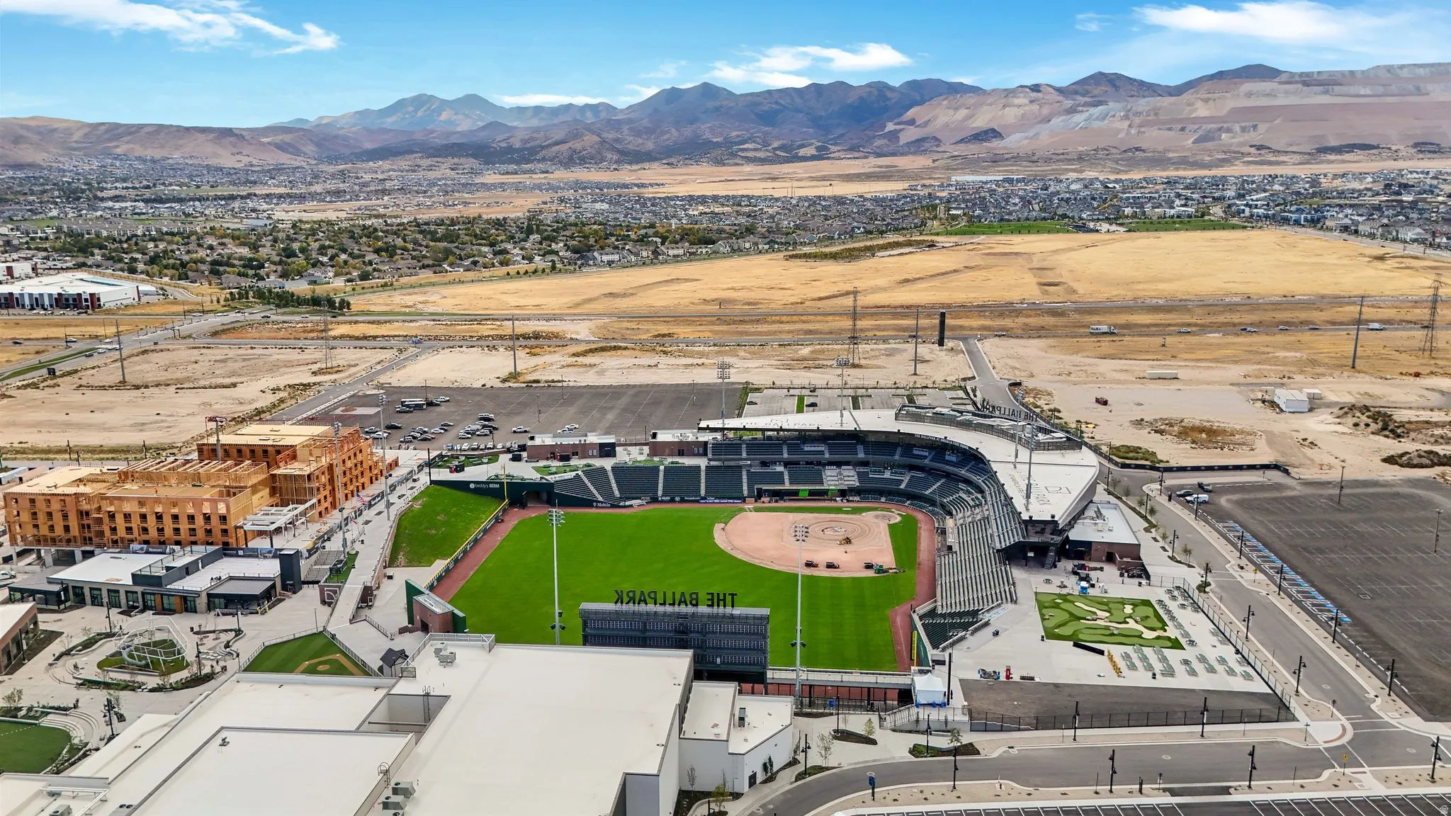 Aerial perspective showcasing "The Ballpark" stadium, surrounded by undeveloped land and residential areas