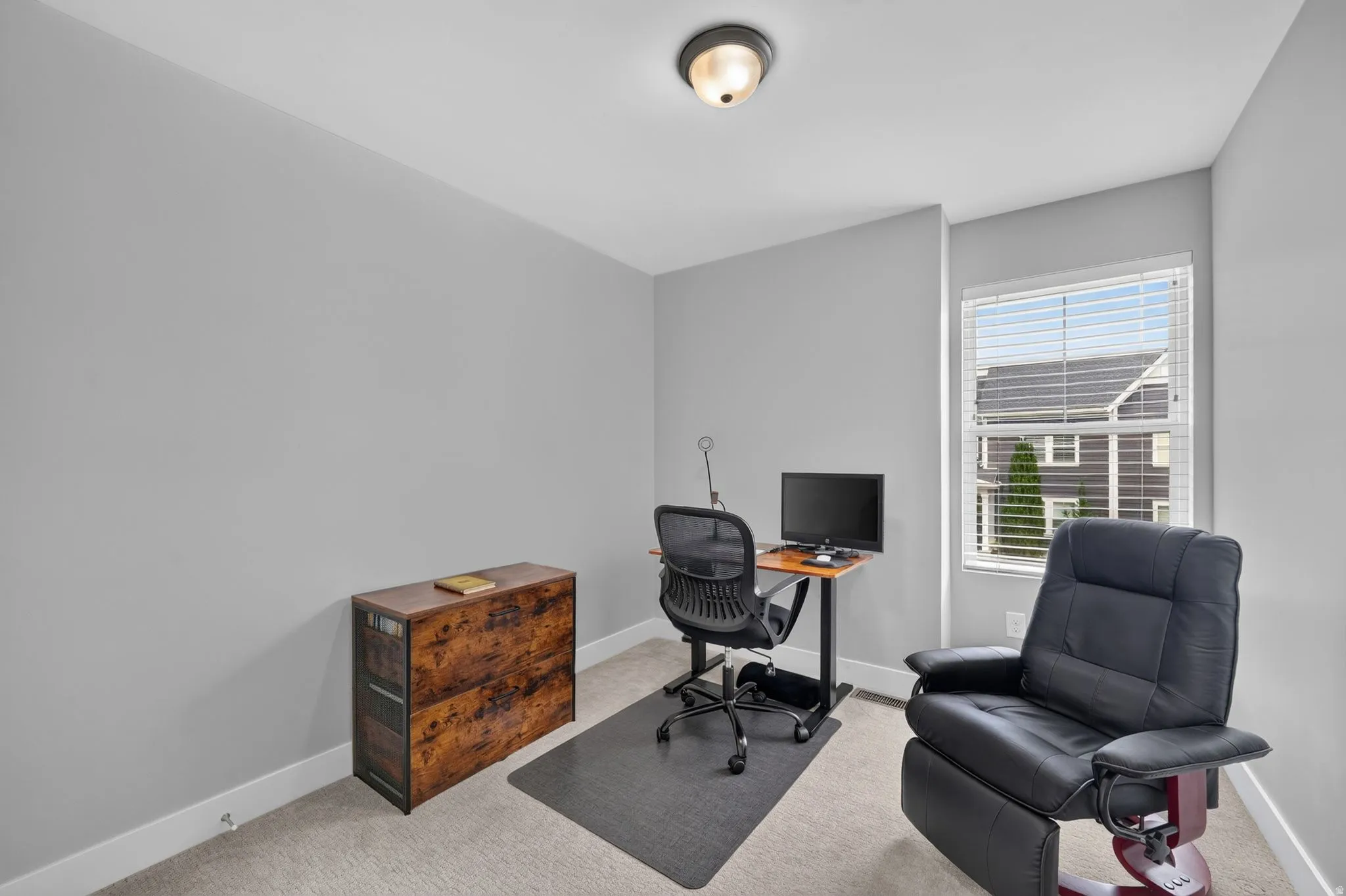 Room featuring light gray wall paint, a single window with blinds, and light-colored carpet flooring